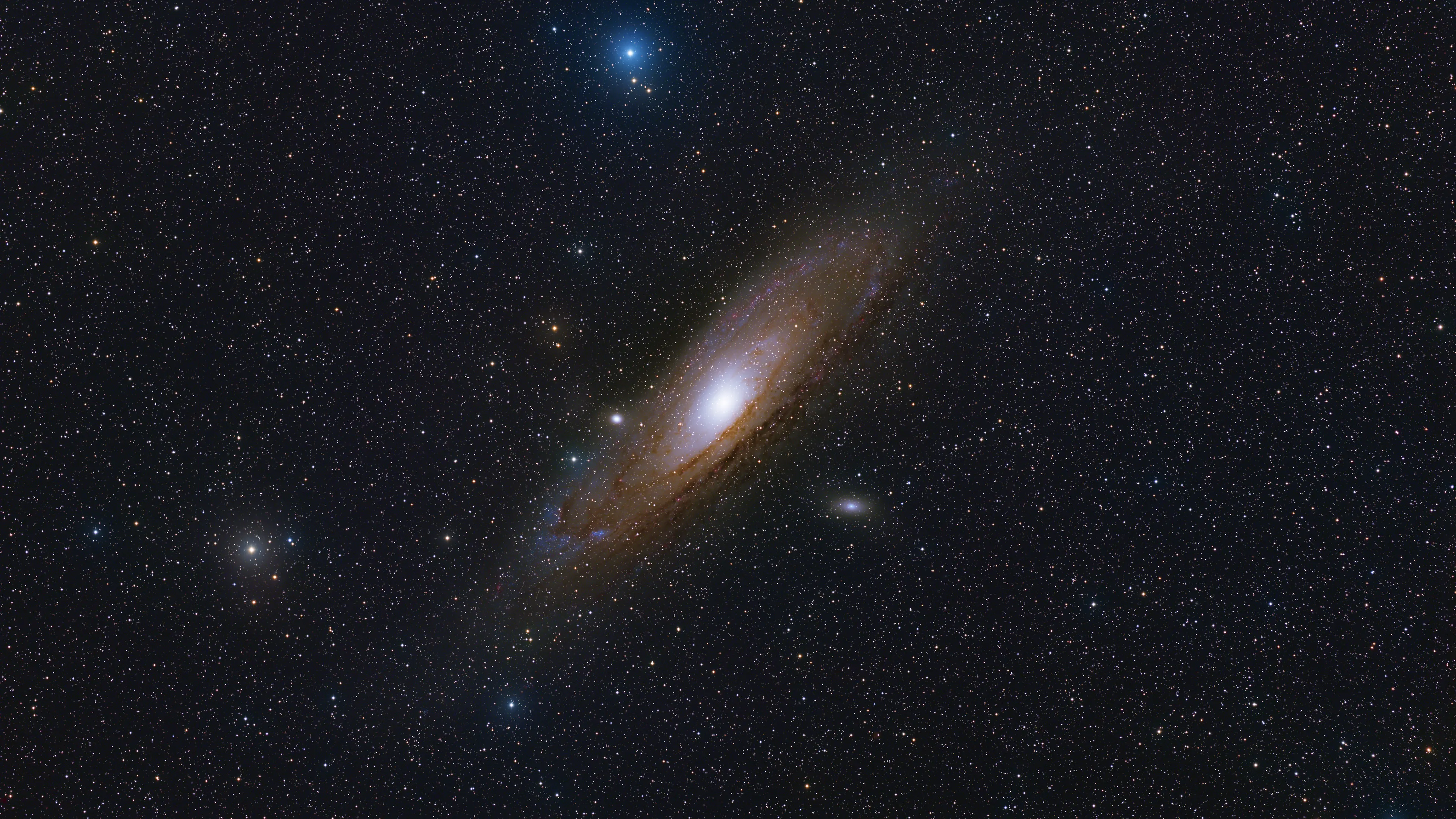 The Andromeda Galaxy with its satellites M32 and M110 and crimson Hα nebulae in its arms