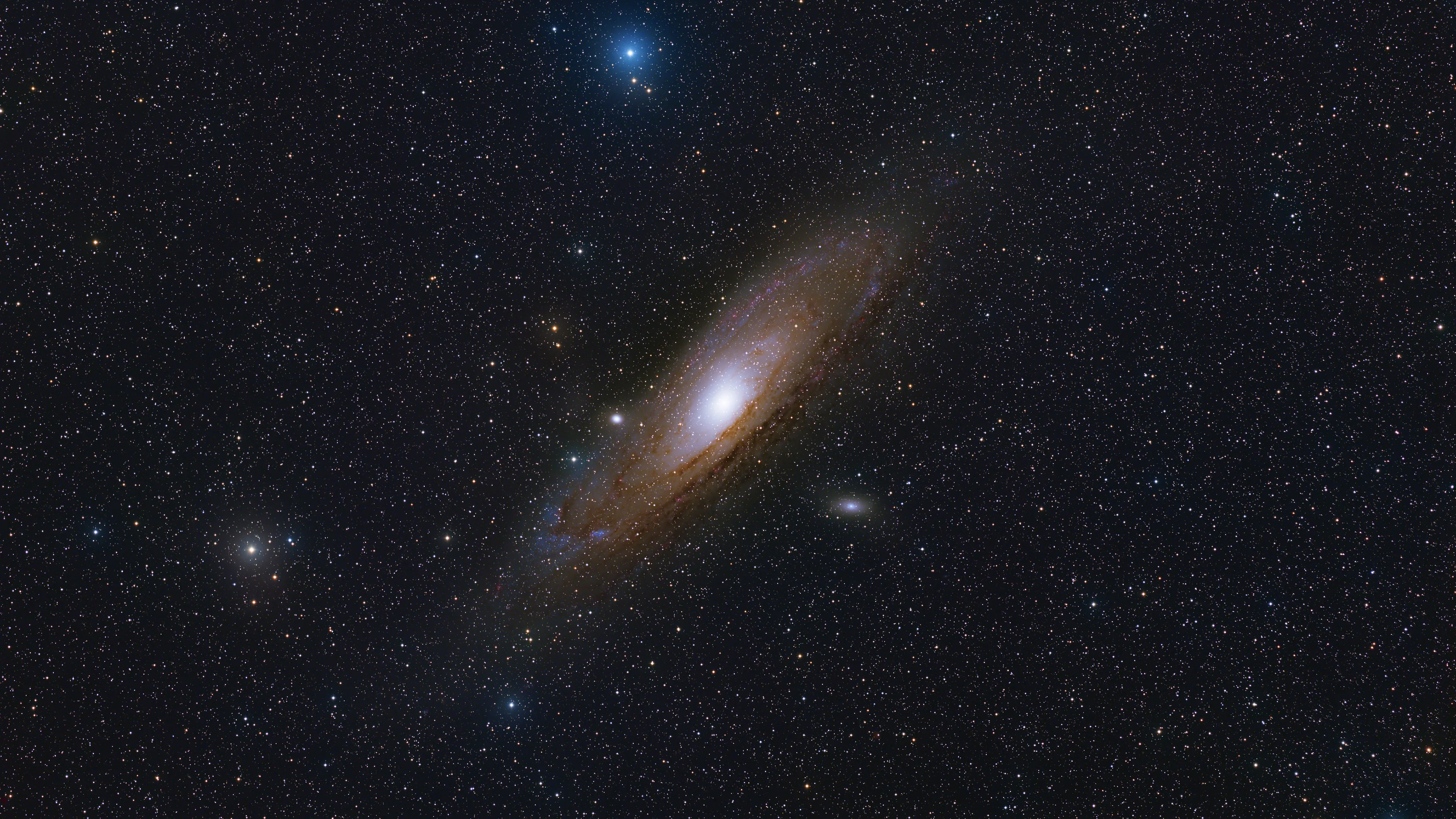 The Andromeda Galaxy with its satellites M32 and M110 and crimson Hα nebulae in its arms